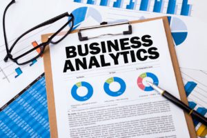 Business Analytics and data with pie charts on a clipboard