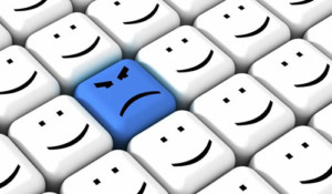 Smiley faces(white) on keyboard with one Frown(blue)