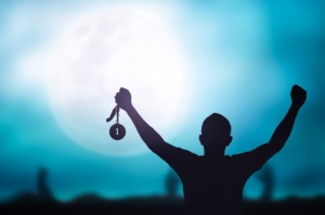 Person's Shadow With hands up Holding Medal with moon in background