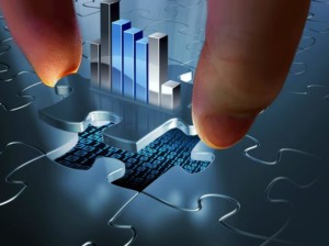 hand placing puzzle piece with background of bar graph