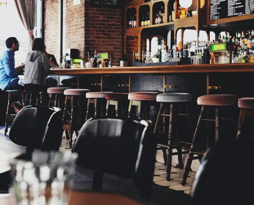 2 People Sitting in a Empty Bar