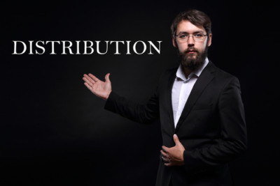 Man in suit(black) Presenting the word Distribution(white) and plain black background