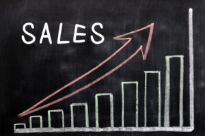 Sales Chart with continual growth show by Bars and Red Line on chalk board