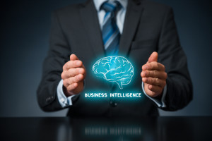 Person in suit's hands surrounding a Brain that says, 'Business Intelligence' beneath(blue)